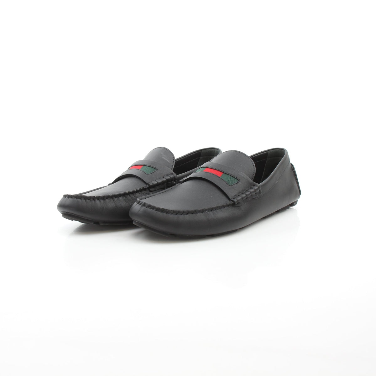 Black leather driver loafers with web detail by Gucci, branded Gold & Beyond