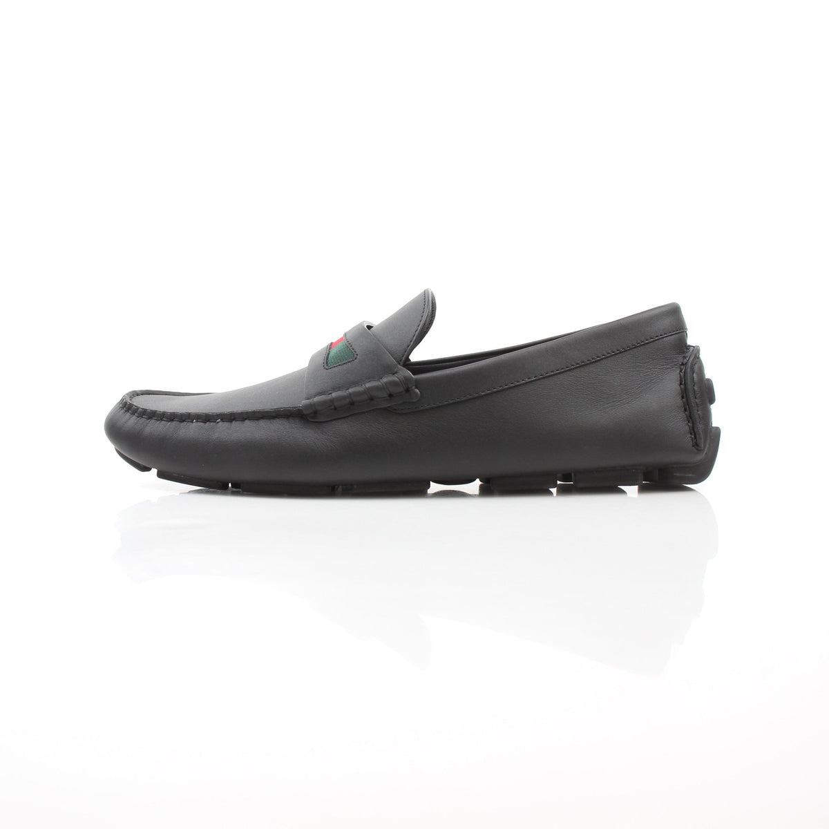 Black leather driver loafers with web detail by Gucci, presented by Gold & Beyond