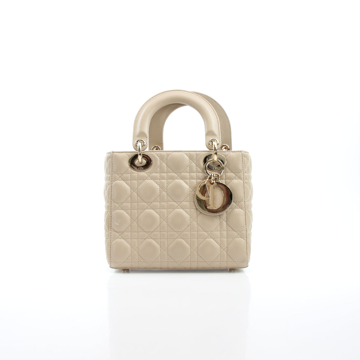Beige Lady Dior medium handbag with cannage lambskin leather and gold hardware, featuring a structured design and top handle.