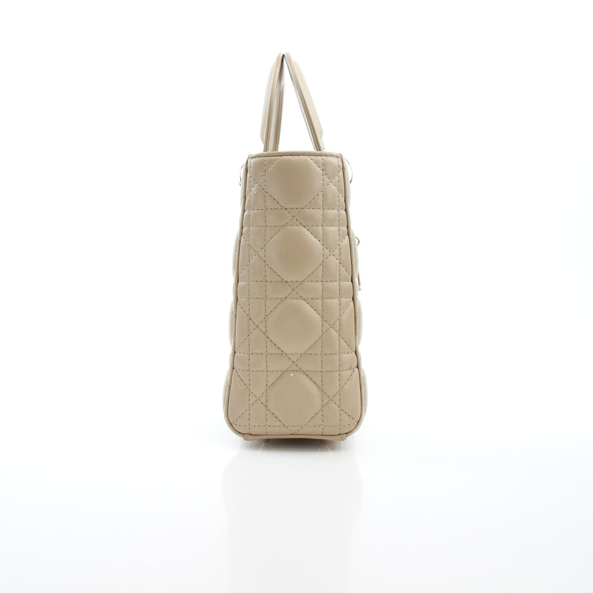 Dior Lady Dior Medium beige cannage lambskin handbag with top handles and signature quilting, displayed against a neutral background.