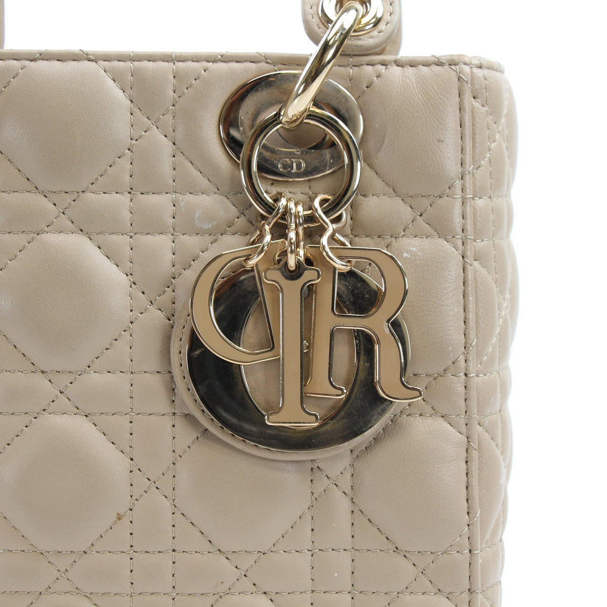 Medium beige Dior Lady Dior handbag with cannage lambskin, featuring gold hardware and elegant design.