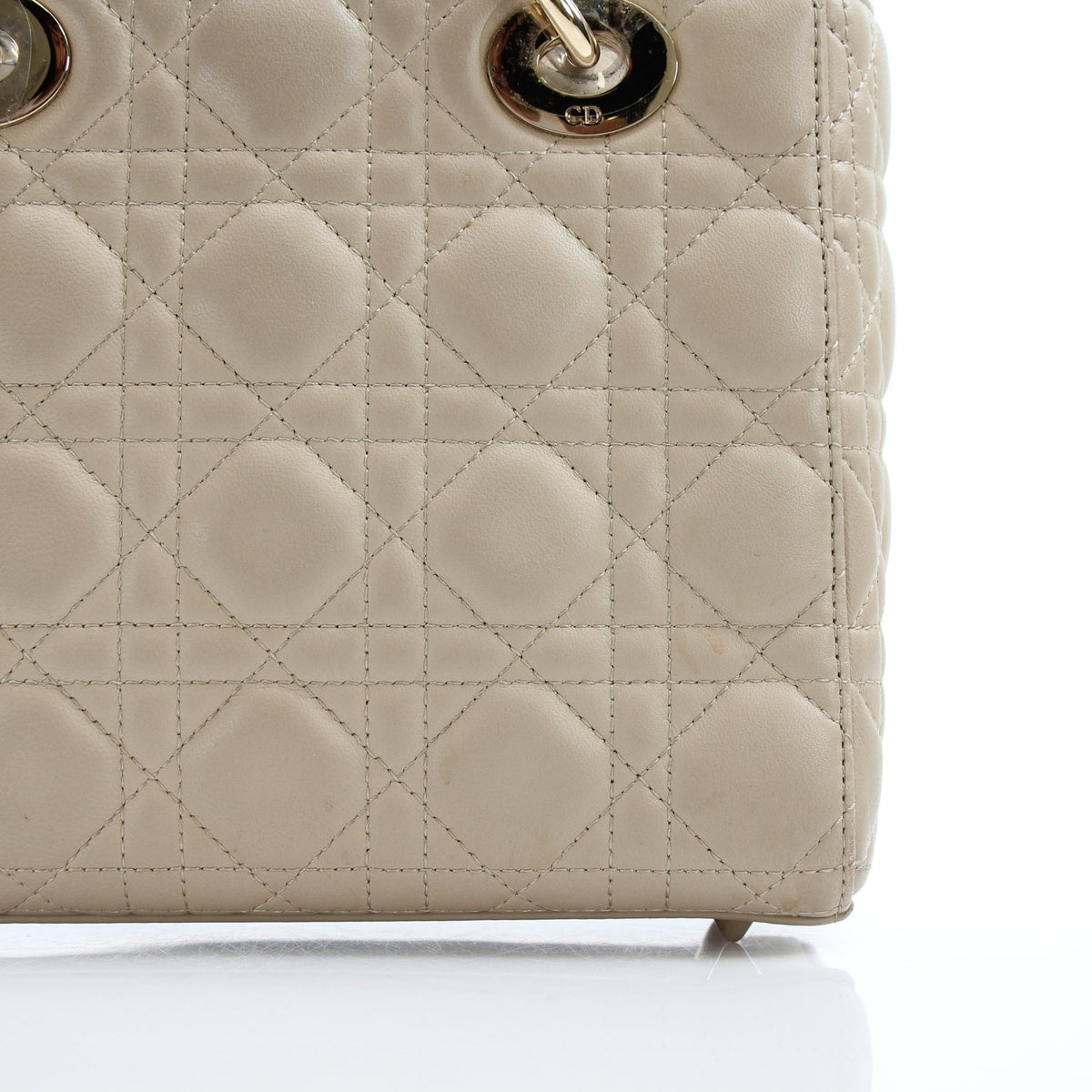 Medium beige Dior Lady Dior handbag with cannage lambskin, featuring gold hardware and signature quilted pattern.