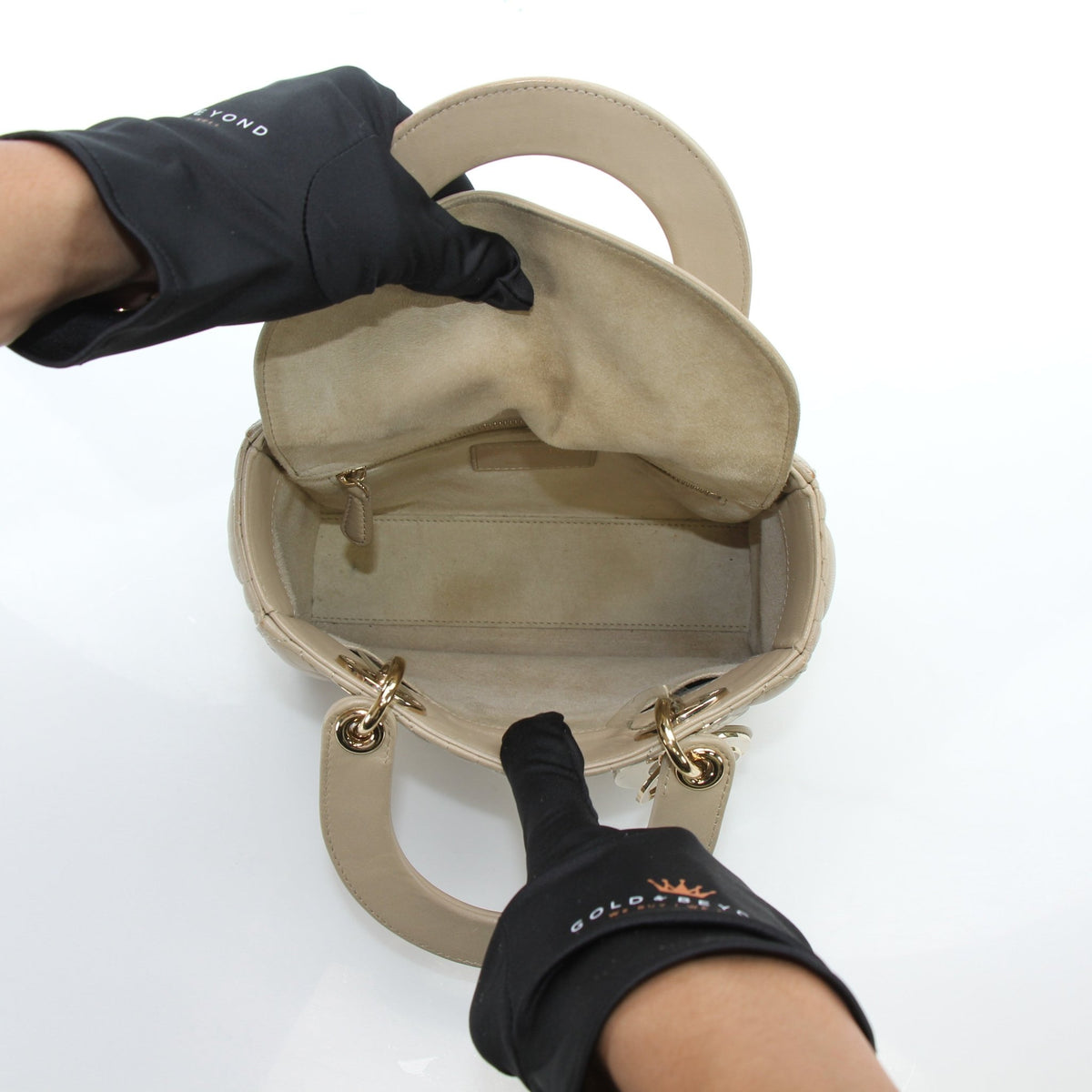 Medium beige Dior Lady Dior handbag with cannage lambskin, featuring gold hardware and structured design.