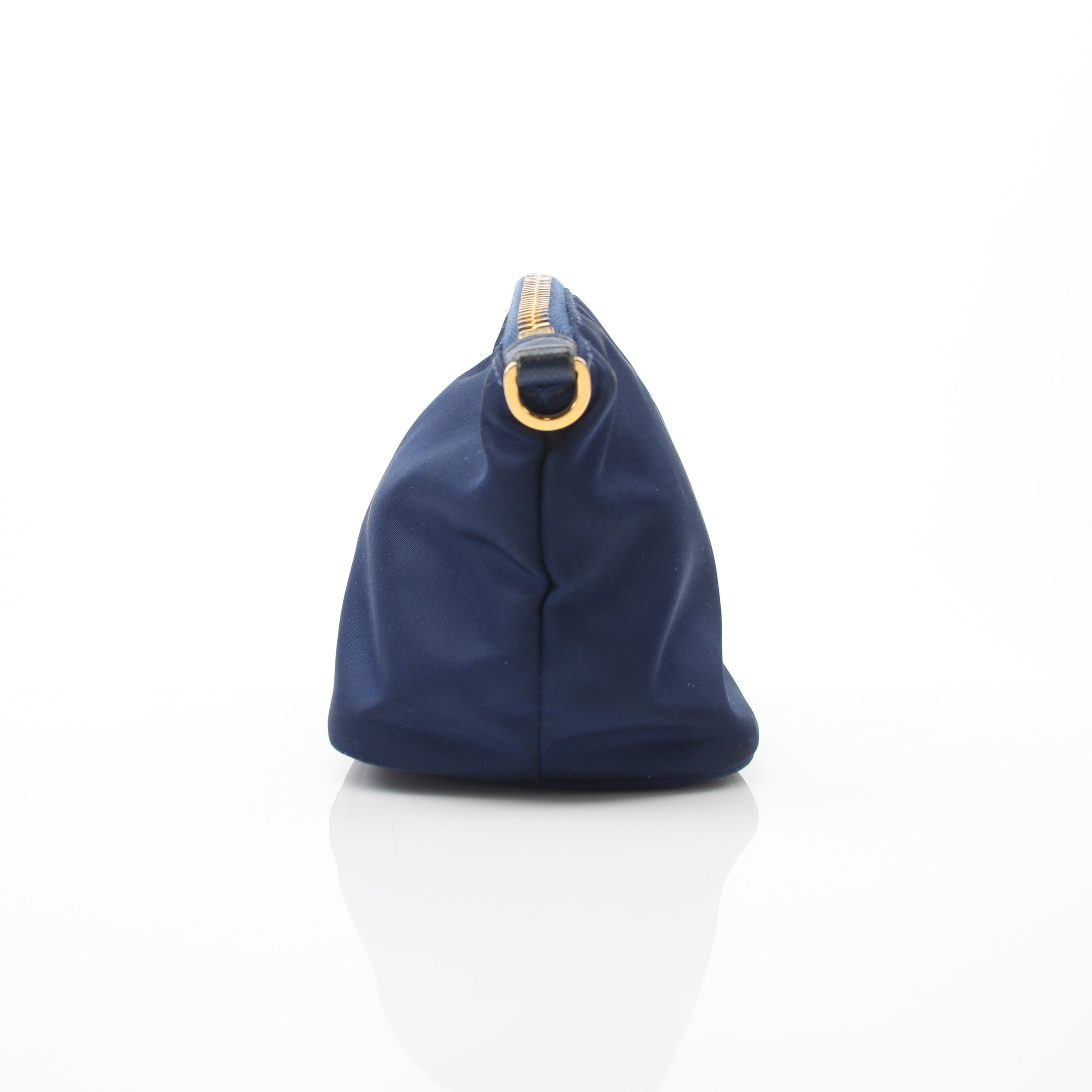 Prada navy blue Re-Nylon mini cosmetic pouch with gold hardware, compact vanity case for travel and everyday use.