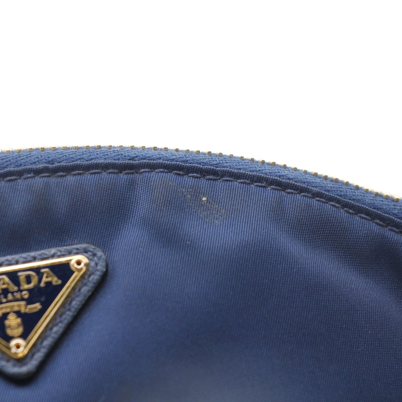 Prada navy blue Re-Nylon cosmetic mini pouch vanity case with gold accents, compact and stylish for travel or everyday use.