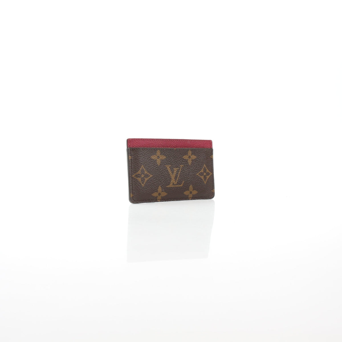 Louis Vuitton Monogram Card Holder in Fuchsia with gold accents, featuring multiple card slots and sleek designer leather.