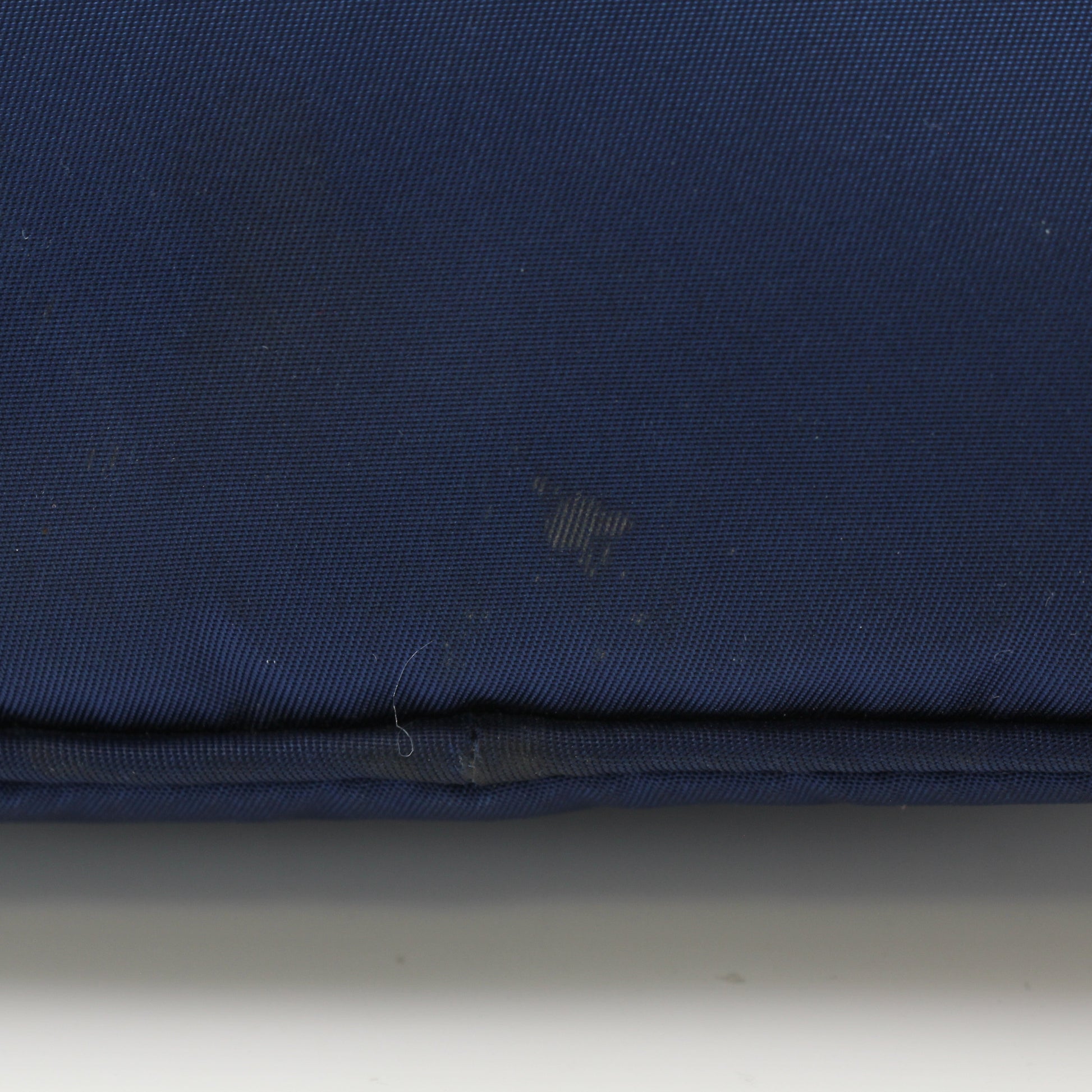 Prada navy blue Re-Nylon cosmetic mini pouch vanity case with zipper closure, compact and stylish for travel.