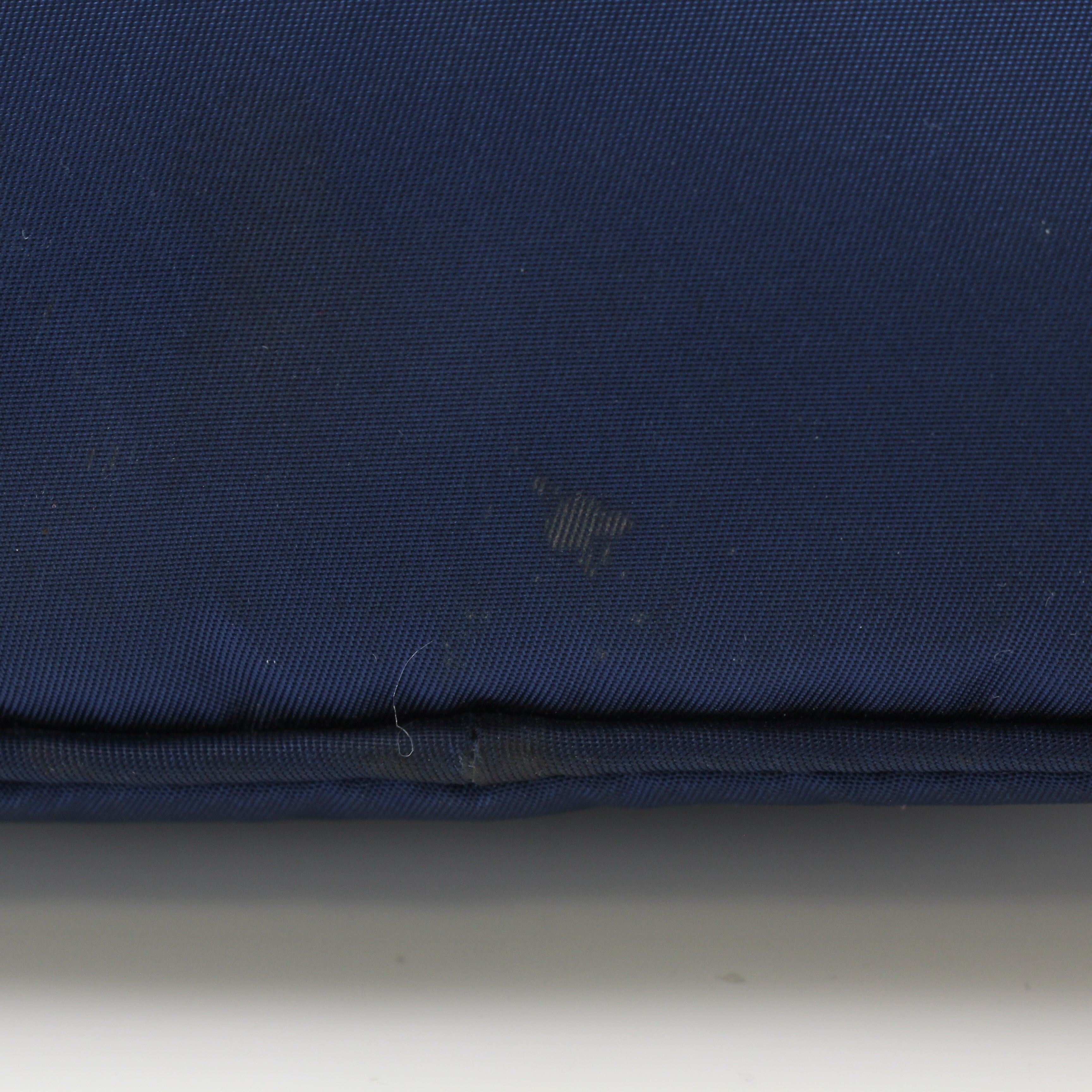 Prada navy blue Re-Nylon cosmetic mini pouch vanity case with zipper closure, compact and stylish for travel.
