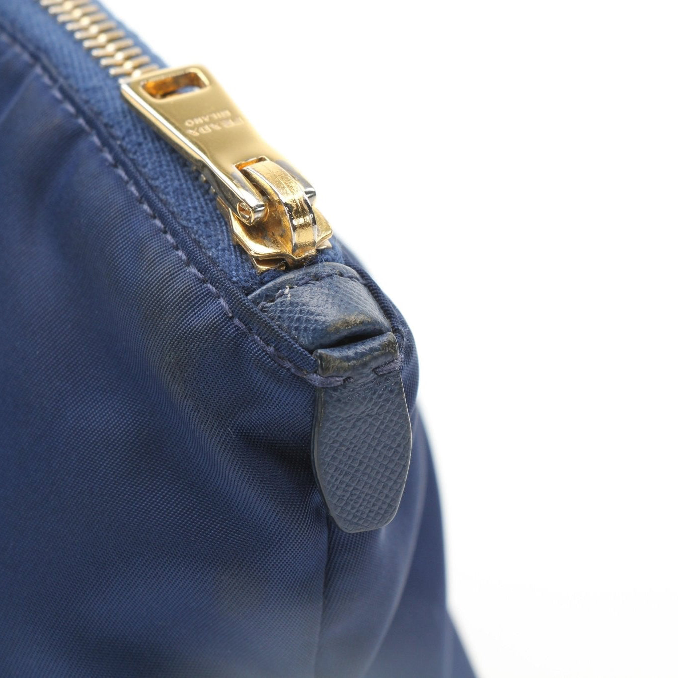 Prada navy blue Re-Nylon mini cosmetic pouch with gold hardware, compact vanity case for makeup and essentials.