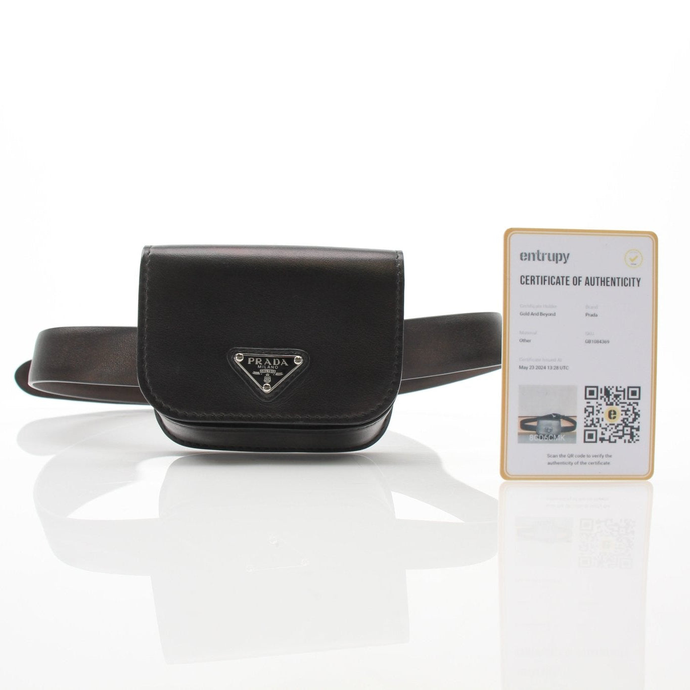 Gold & Beyond Prada black logo plaque belt bag styled as a wallet with branding and sleek design visible in the image.