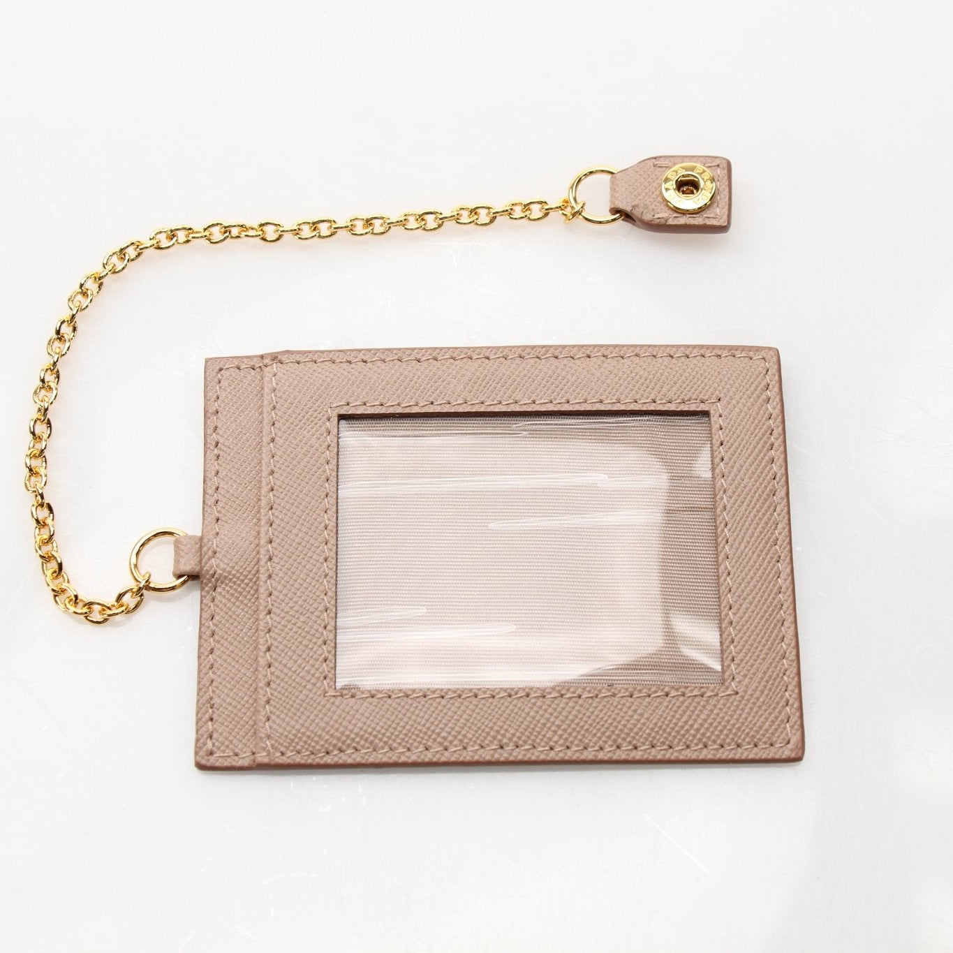 Prada Saffiano Lux beige continental flap wallet with gold hardware, showcasing textured leather and elegant design.