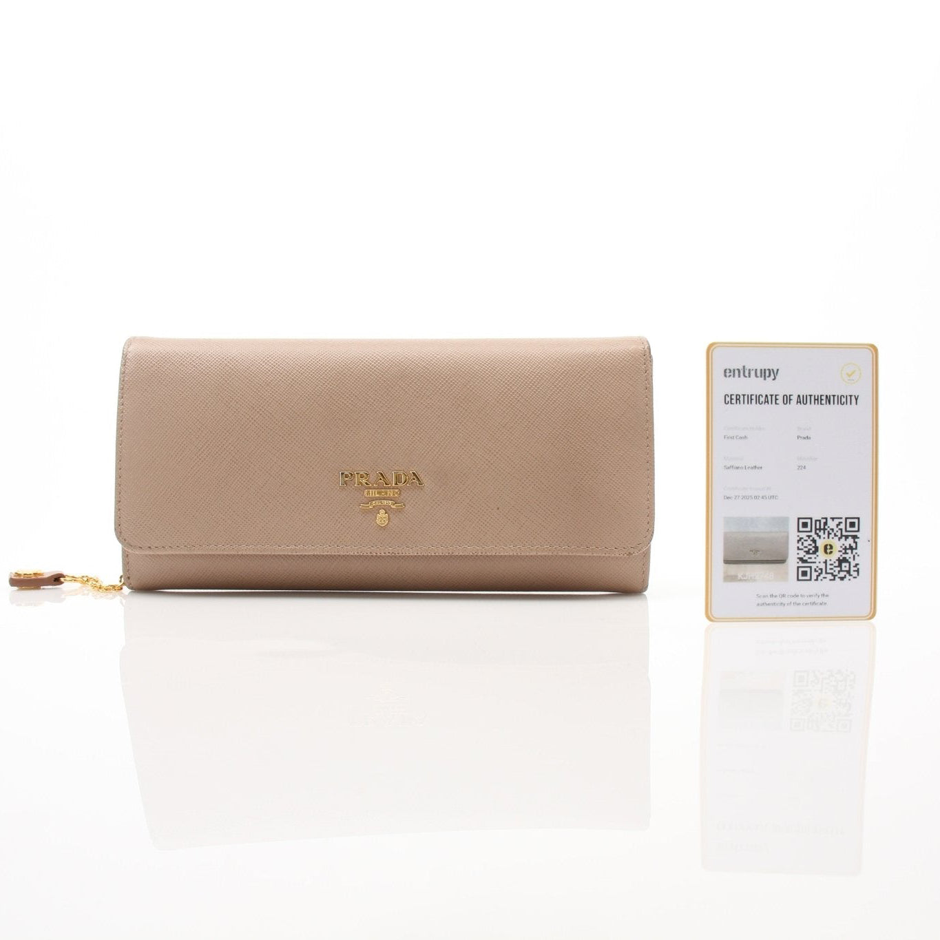 Beige Prada Saffiano Lux continental flap wallet with gold hardware and textured leather, displayed on a neutral background.