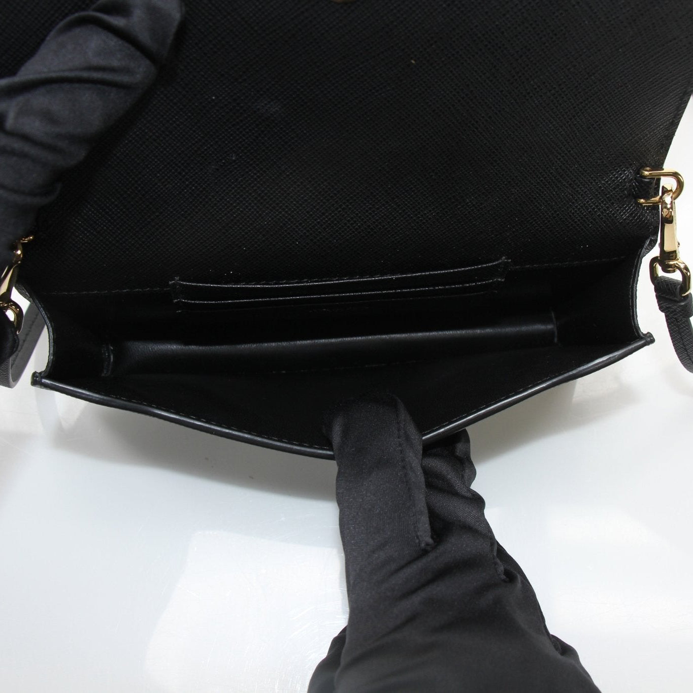 Gold & Beyond Prada Mini Crossbody Bag handbag with gold chain strap and sleek design, shown in a close-up shot.