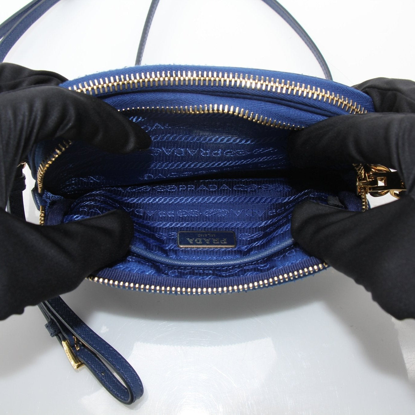 Prada blue nylon crossbody handbag with adjustable strap, featuring sleek design and Gold & Beyond branding.