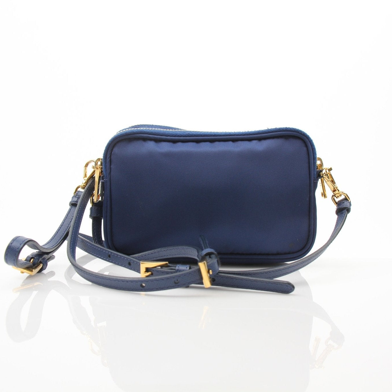Blue Prada nylon crossbody handbag with adjustable strap and gold hardware, styled for casual and chic looks.