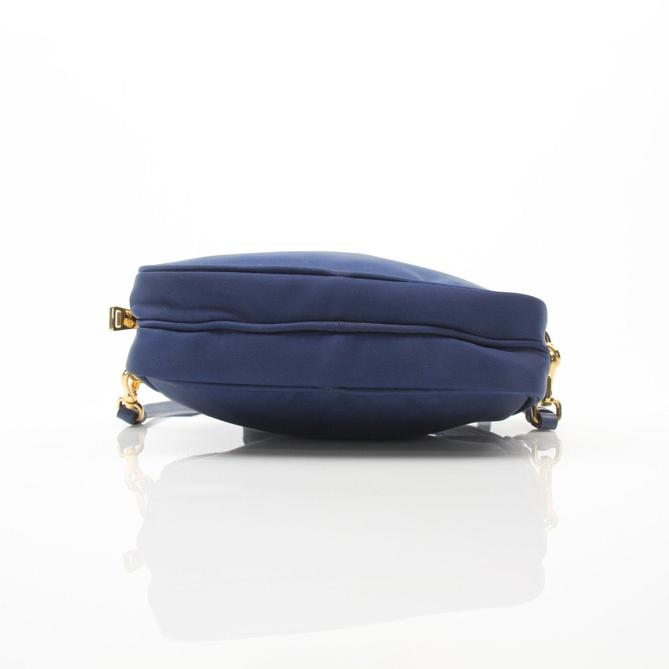 Prada blue nylon crossbody handbag with adjustable strap, compact design, and gold-tone hardware.