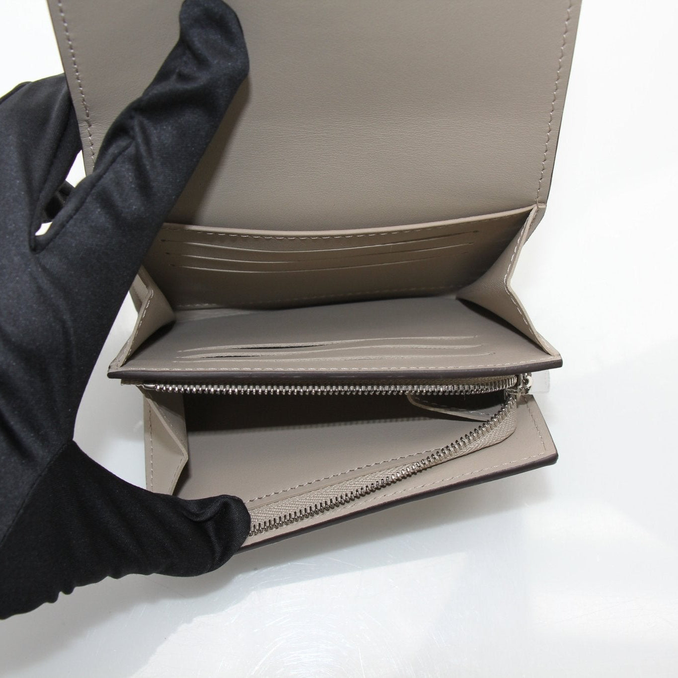Gold & Beyond Louis Vuitton Iris compact wallet with gold accents, featuring a sleek design and multiple card slots.