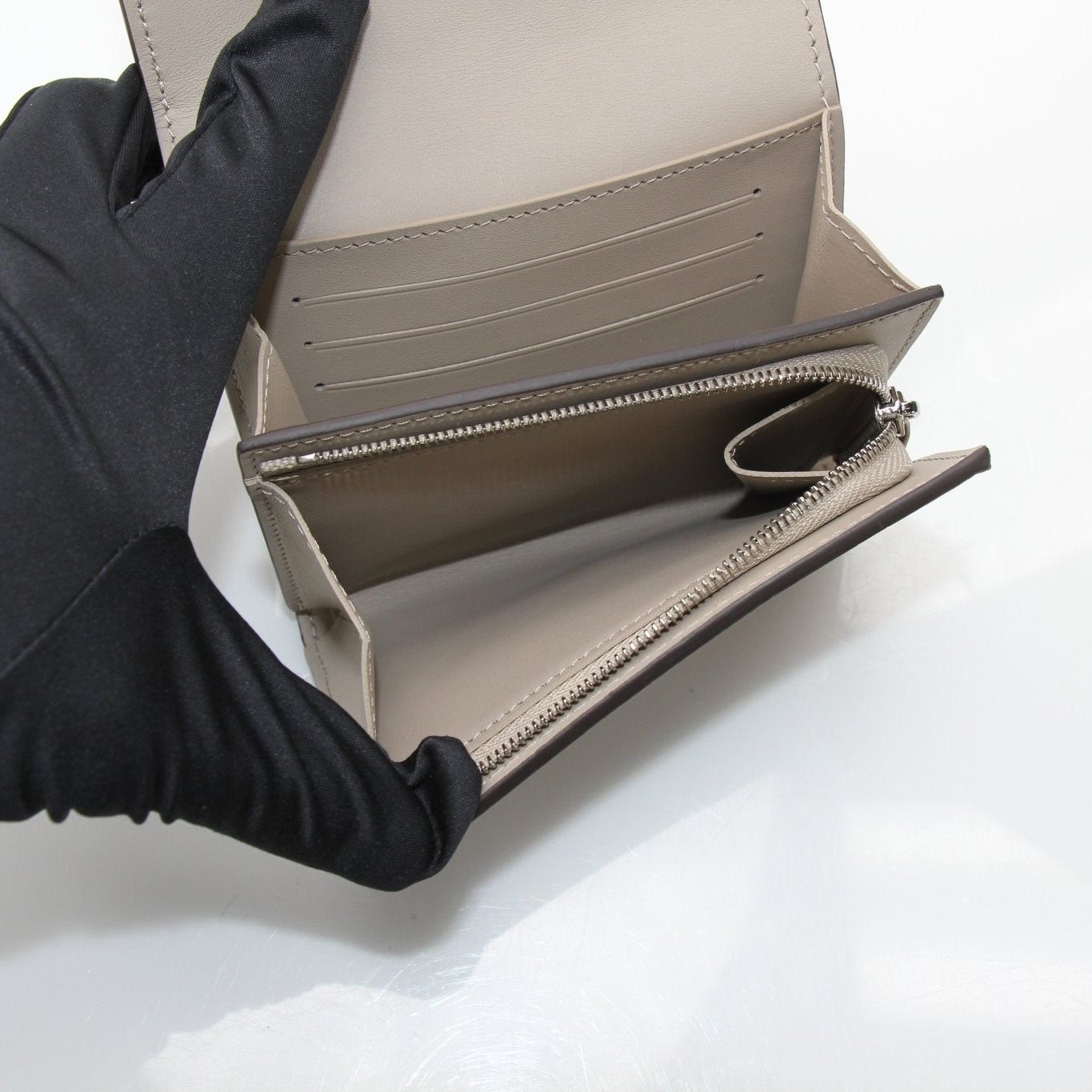 Louis Vuitton Iris compact wallet by Gold & Beyond, showing the elegant leather exterior and gold-tone hardware details.