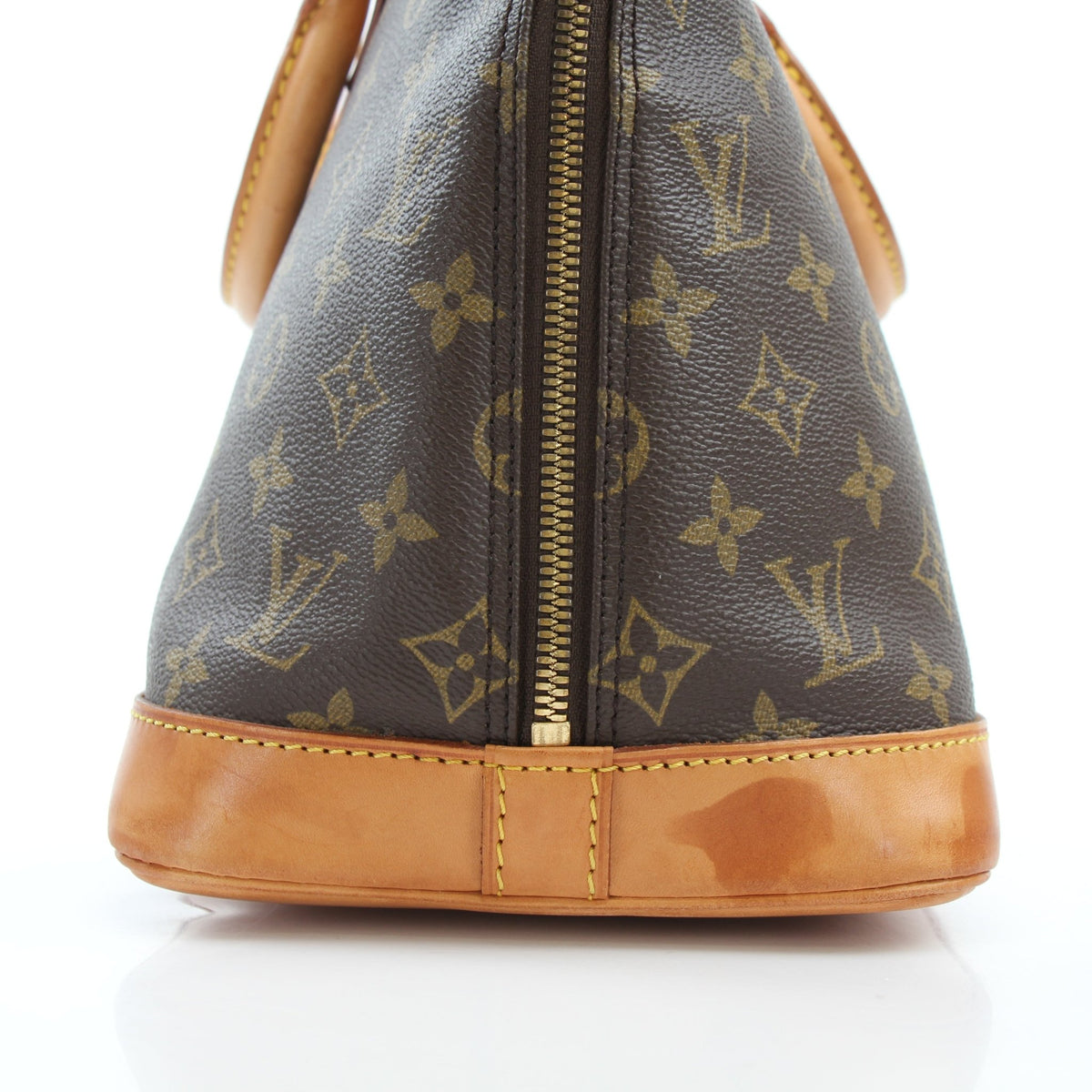 Louis Vuitton Monogram Alma PM handbag in brown coated canvas with gold hardware and structured design.