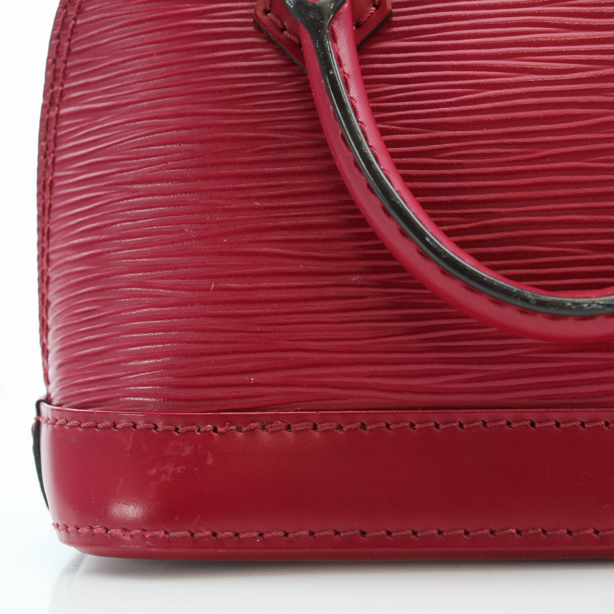 Louis Vuitton Epi Nano Alma red leather handbag with gold hardware, featuring structured shape and top handles.