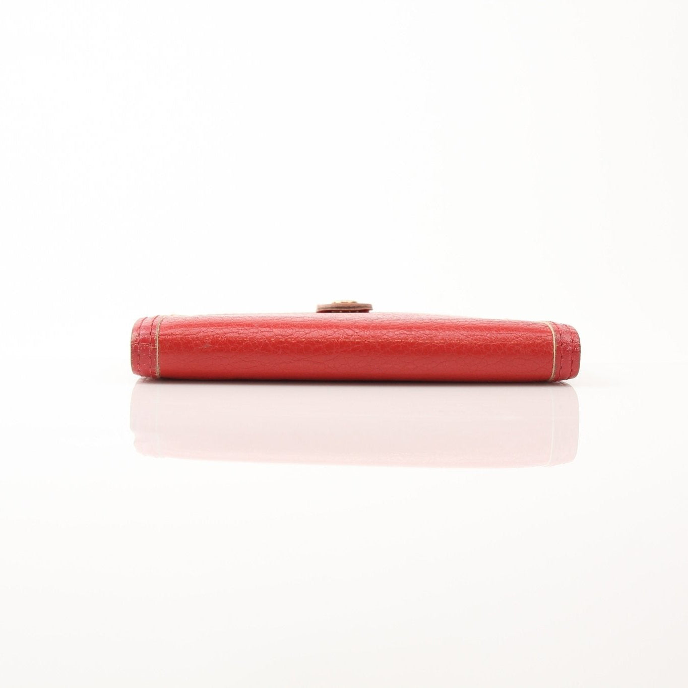 Louis Vuitton Suhali Le Fabuleux red agenda PM compact planner cover with gold accents, showcasing luxurious leather accessories.