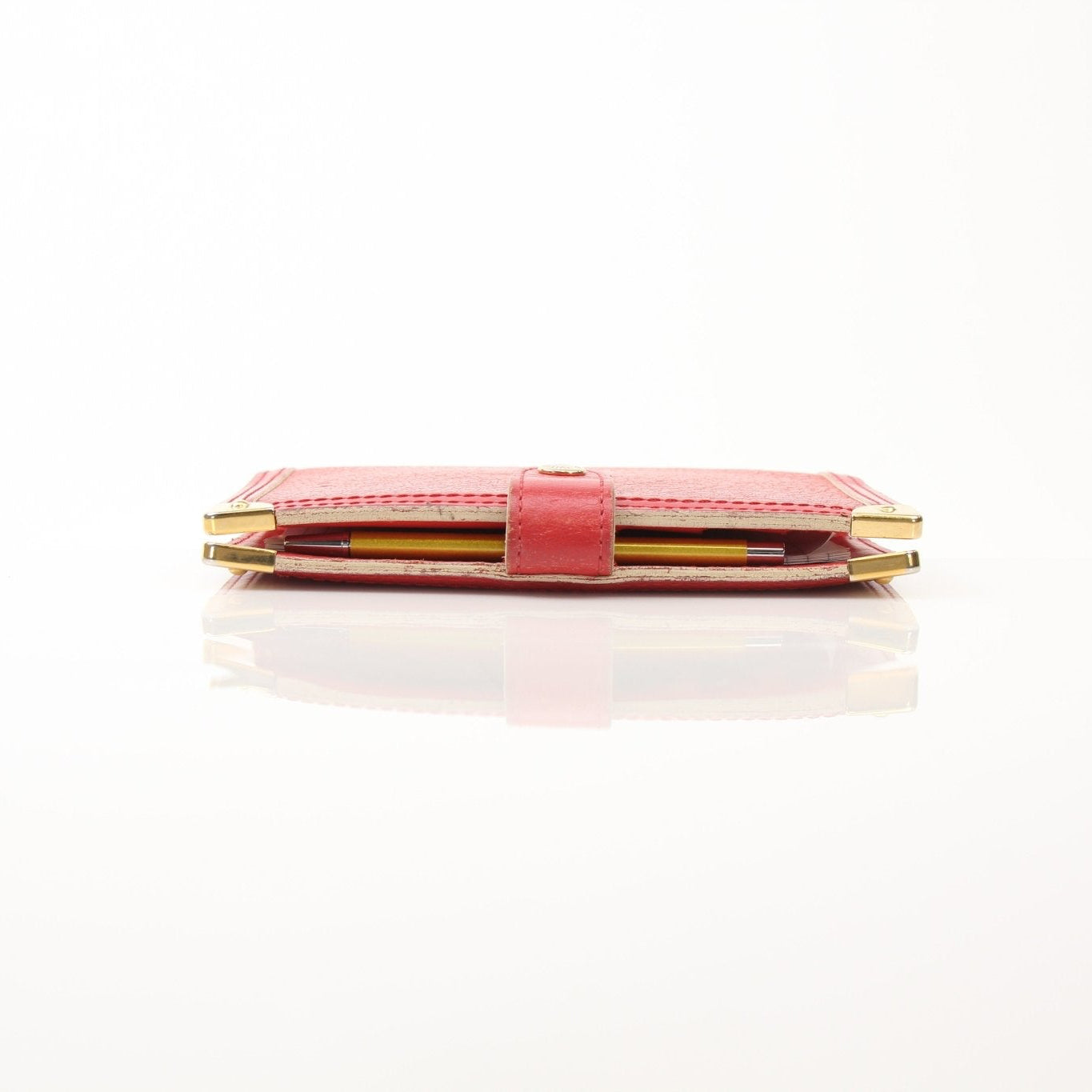 Louis Vuitton Suhali Le Fabuleux Red Agenda PM compact planner cover with gold accents and detailed stitching.