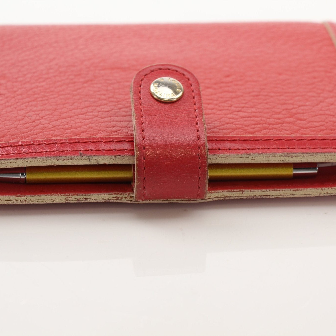 Louis Vuitton Suhali Le Fabuleux red agenda PM compact planner cover with gold accents, designed for accessories and organization.