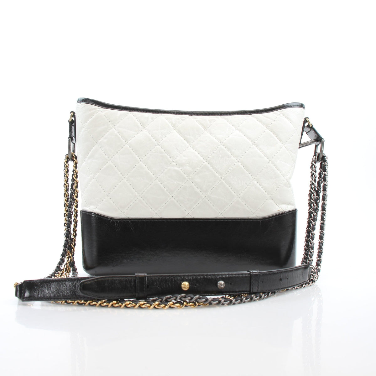 Chanel Gabrielle Medium Hobo Bag in white leather with gold hardware, featuring a slouchy handbag design and shoulder strap.