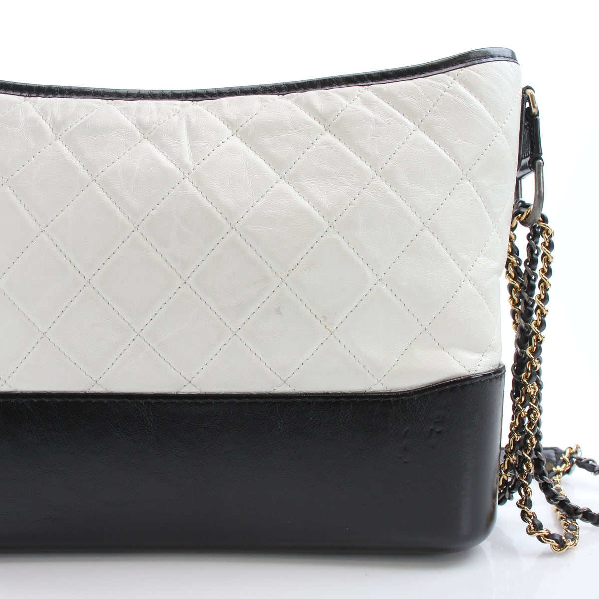 White leather Chanel Gabrielle medium hobo handbag with gold-tone hardware and soft, slouchy design.