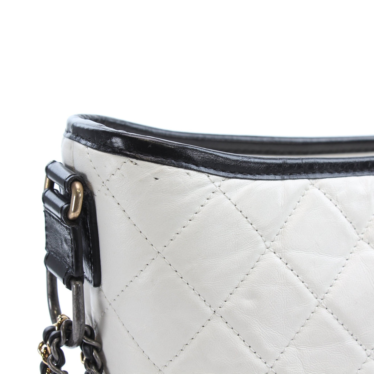 White Chanel Gabrielle Medium Hobo Bag in leather with gold-tone hardware, showcasing its stylish design and spacious interior.