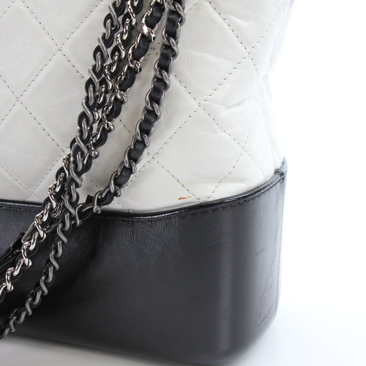 White leather Chanel Gabrielle Medium Hobo Bag, elegant handbag with gold hardware and spacious design.