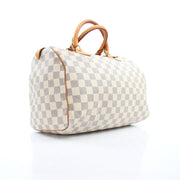 Louis Vuitton Damier Azur Speedy 30 handbag with gold hardware, featuring the signature checkered pattern and leather handles.