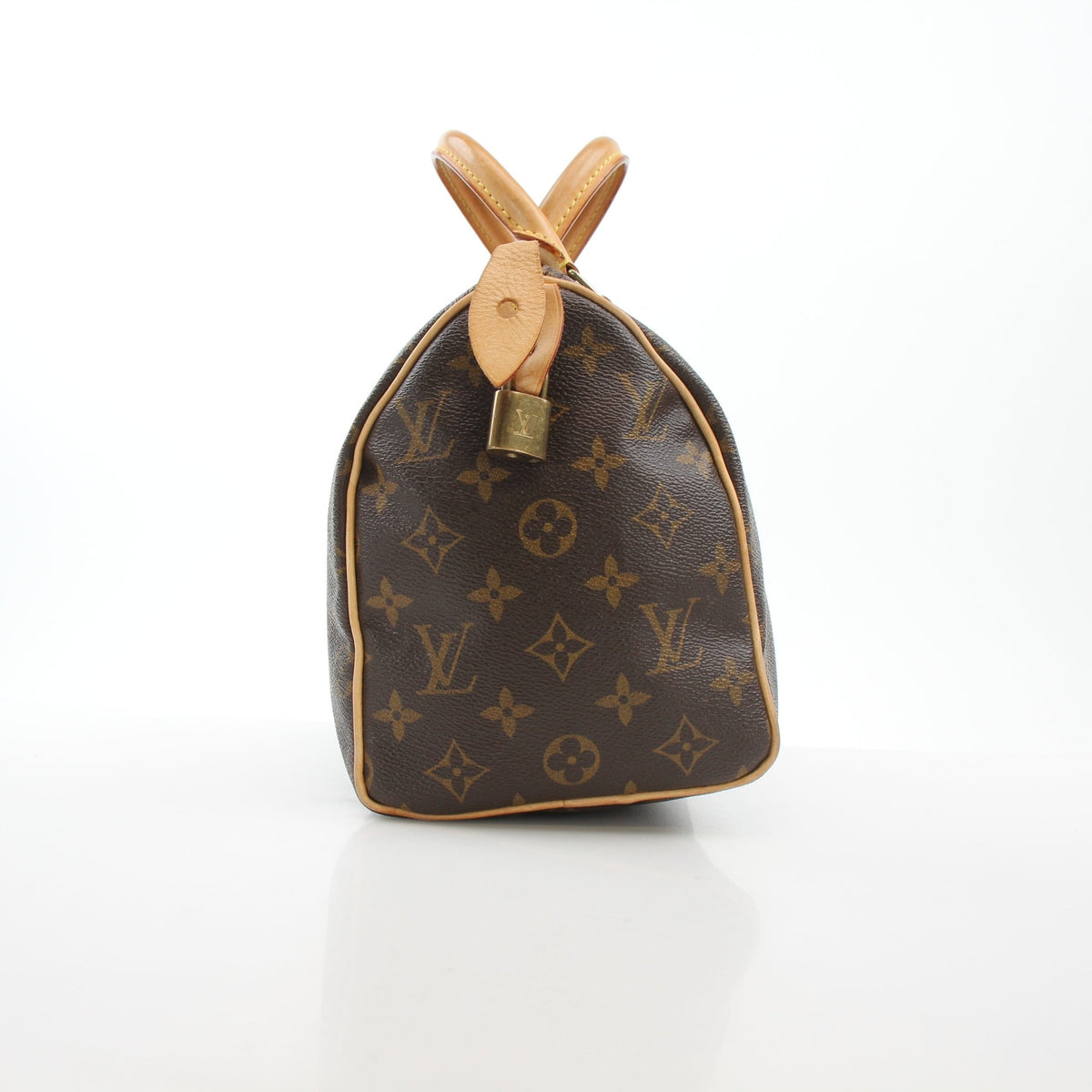 Louis Vuitton Monogram Speedy 25 handbag with leather handles and gold-tone hardware, featuring the signature LV monogram canvas.