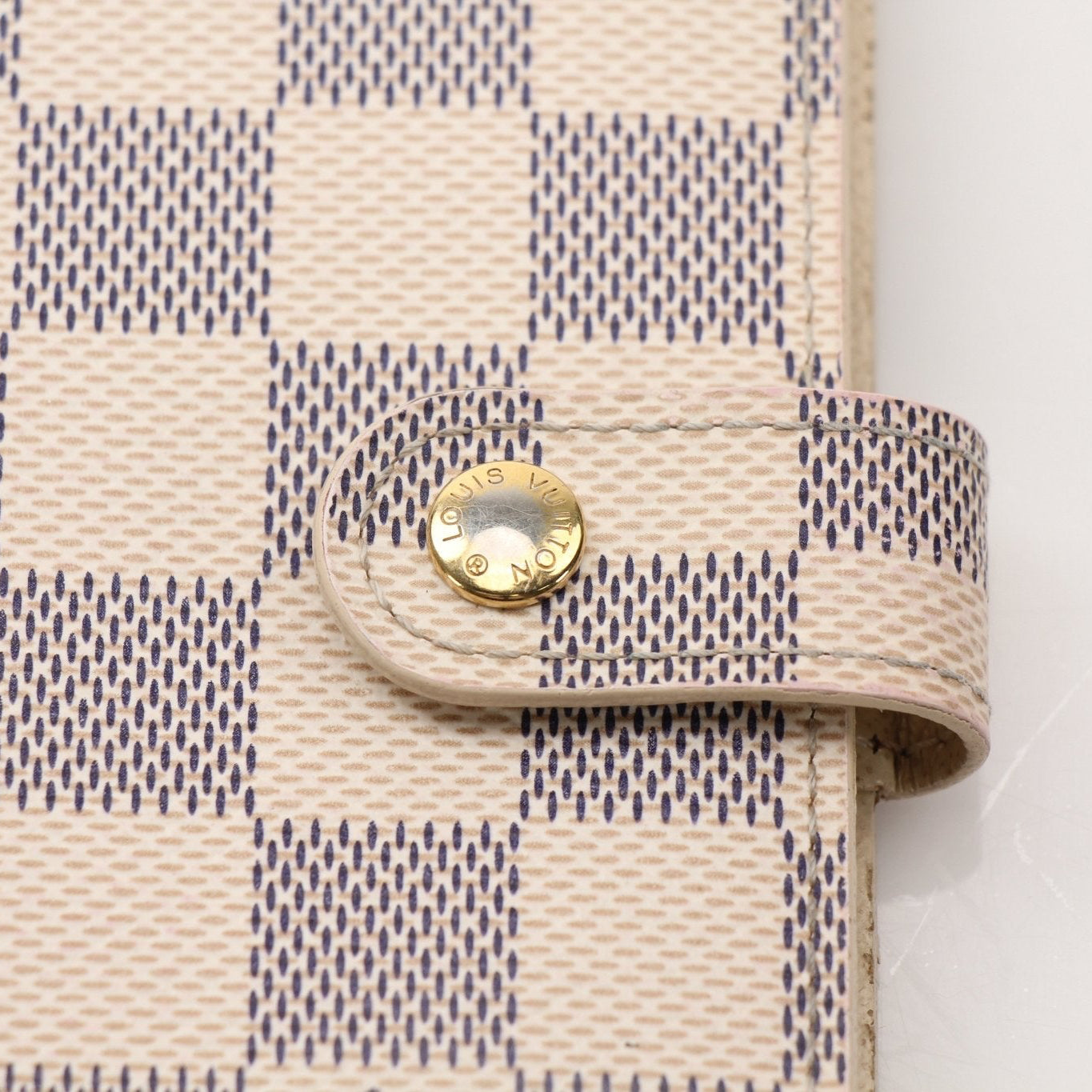 Louis Vuitton Damier Azur Agenda PM leather accessories with gold detailing, featuring the signature checkered pattern.