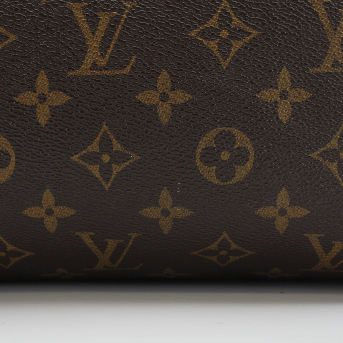 Louis Vuitton Monogram Speedy 25 handbag with leather handles and gold hardware, showcasing the iconic monogram canvas and structured shape.