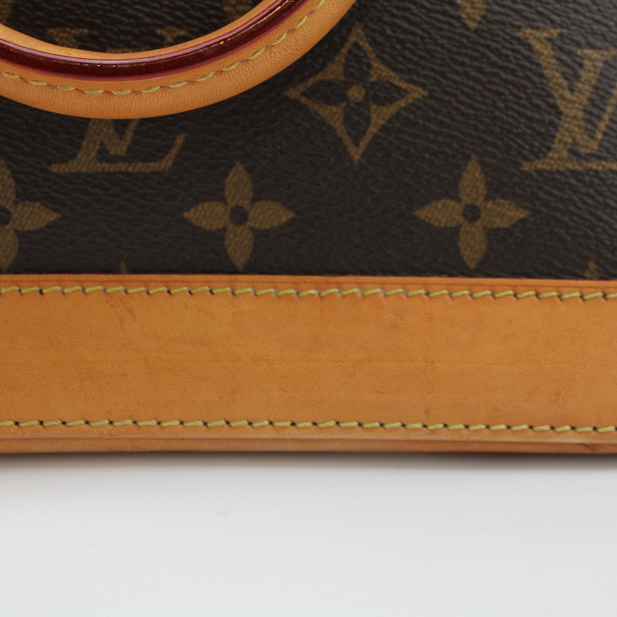 Louis Vuitton Brown Alma BB handbag by Gold & Beyond, featuring smooth leather and gold-tone hardware, displayed on a neutral background.