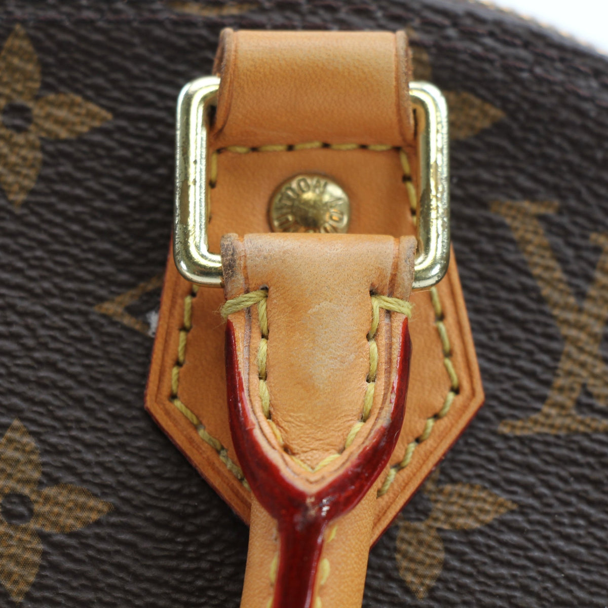 Brown Louis Vuitton Alma BB handbag with gold hardware, featuring structured design and top handles, displayed on a neutral background.