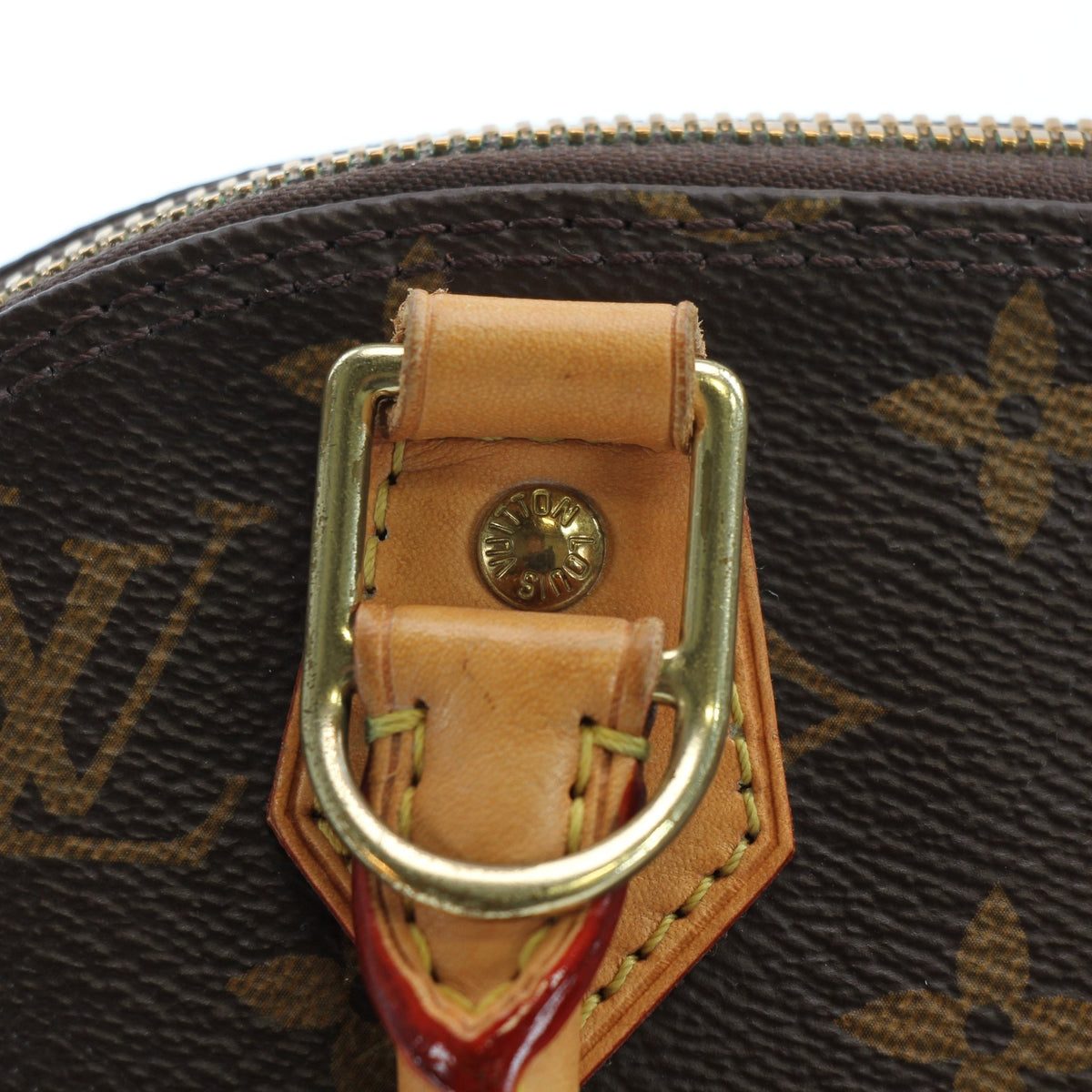 Louis Vuitton Brown Alma BB handbag with gold accents, showcasing its structured design and signature monogram canvas.