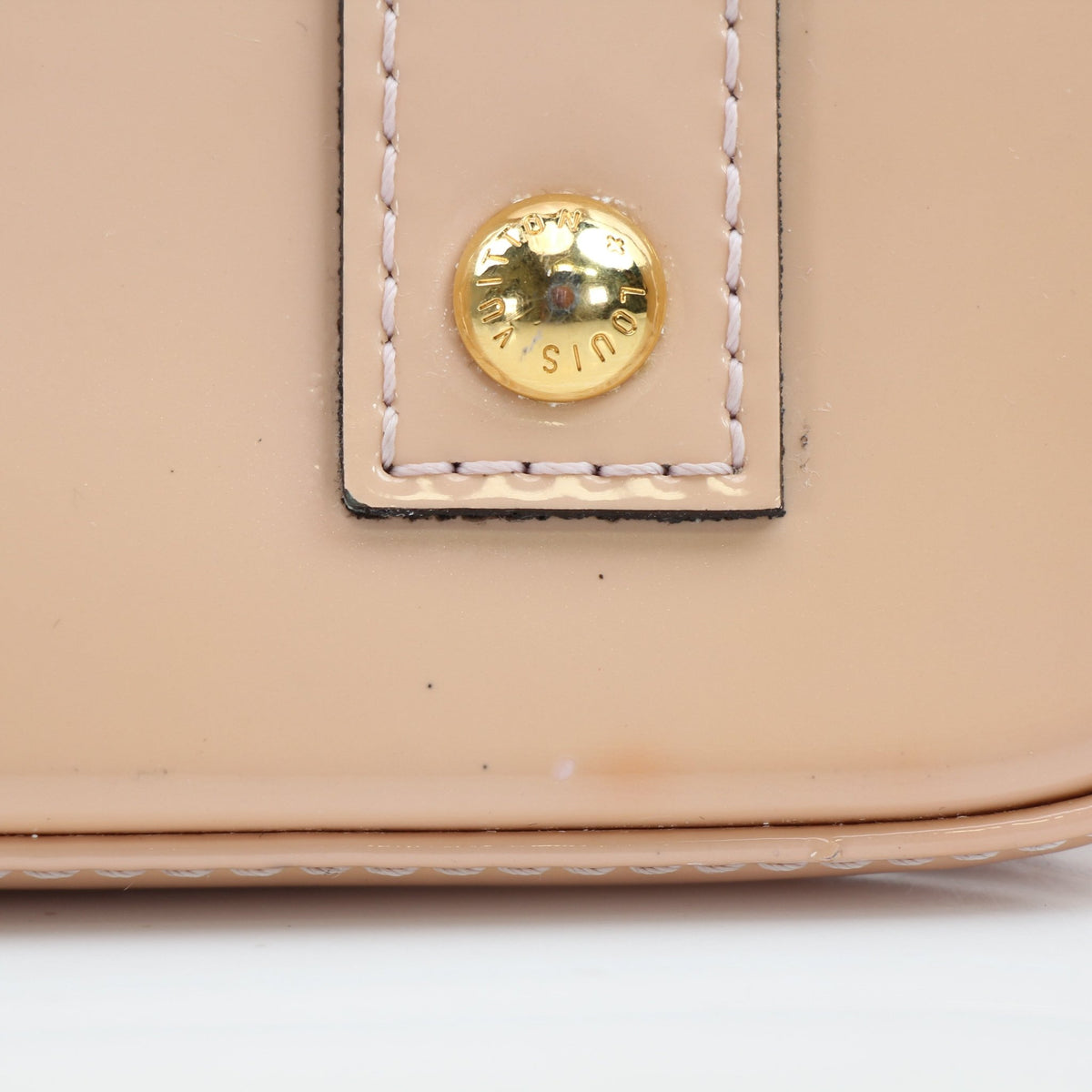 Louis Vuitton Blush Pink Alma BB handbag with gold-tone hardware, featuring structured leather and top handles.