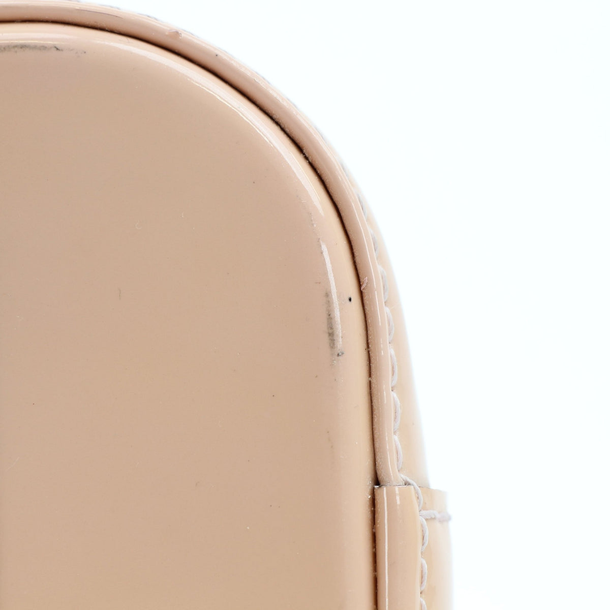 Blush pink Louis Vuitton Alma BB handbag with gold hardware, featuring structured leather design and top handle.
