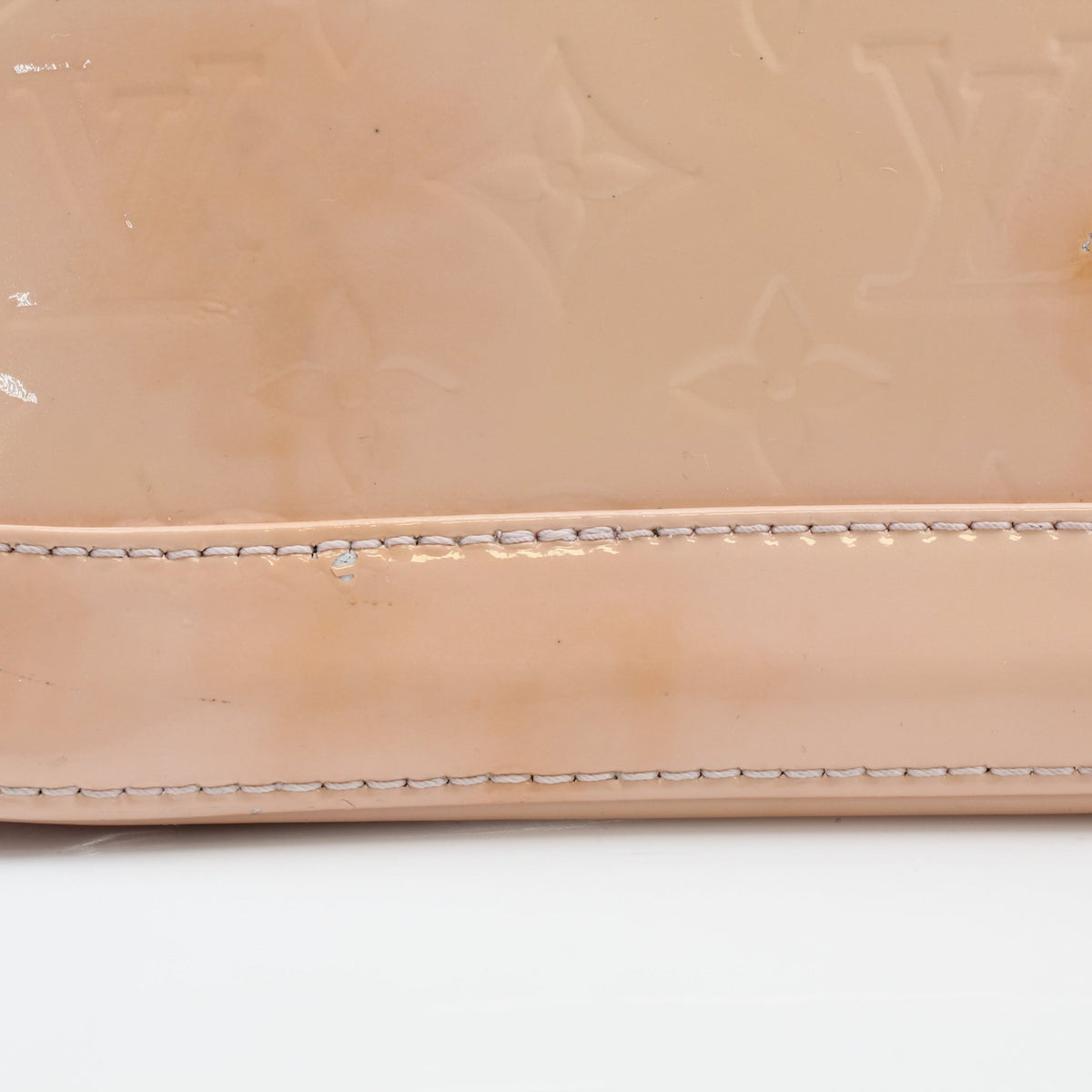 Louis Vuitton blush pink Alma BB handbag with gold hardware, featuring structured leather design and top handles.