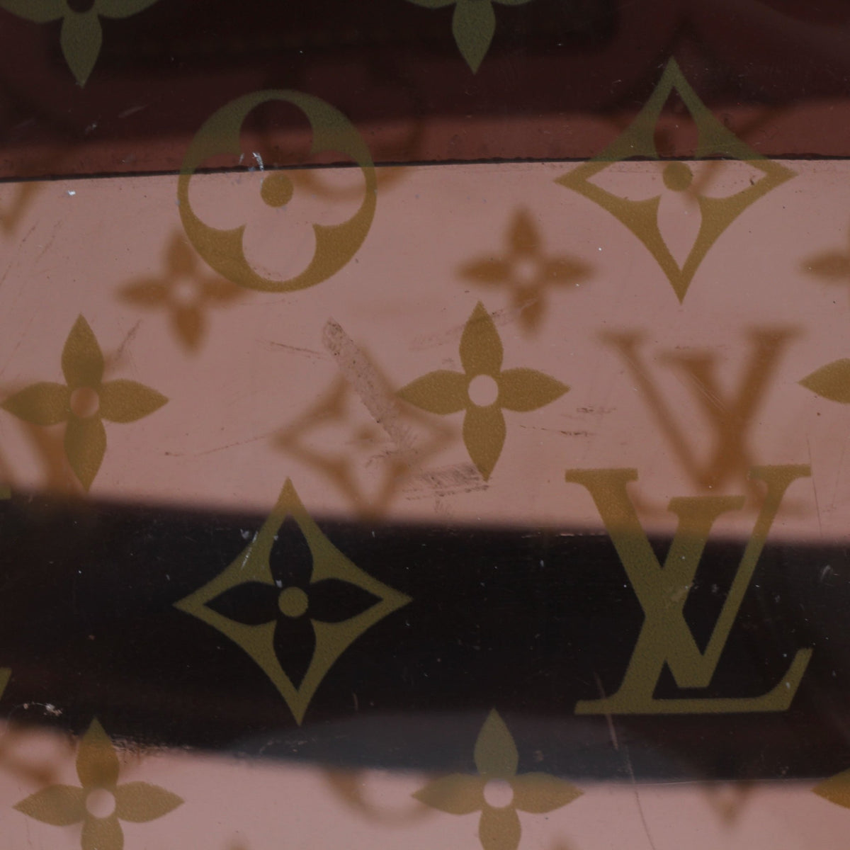 Louis Vuitton Cabas Ambre PM tote handbag with tan leather handles and monogram canvas, displayed against a neutral background.