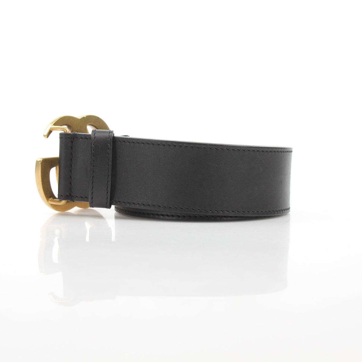 Gucci GG Marmont wide belt in black leather, accessories, featuring the signature GG logo buckle on a sleek leather strap.