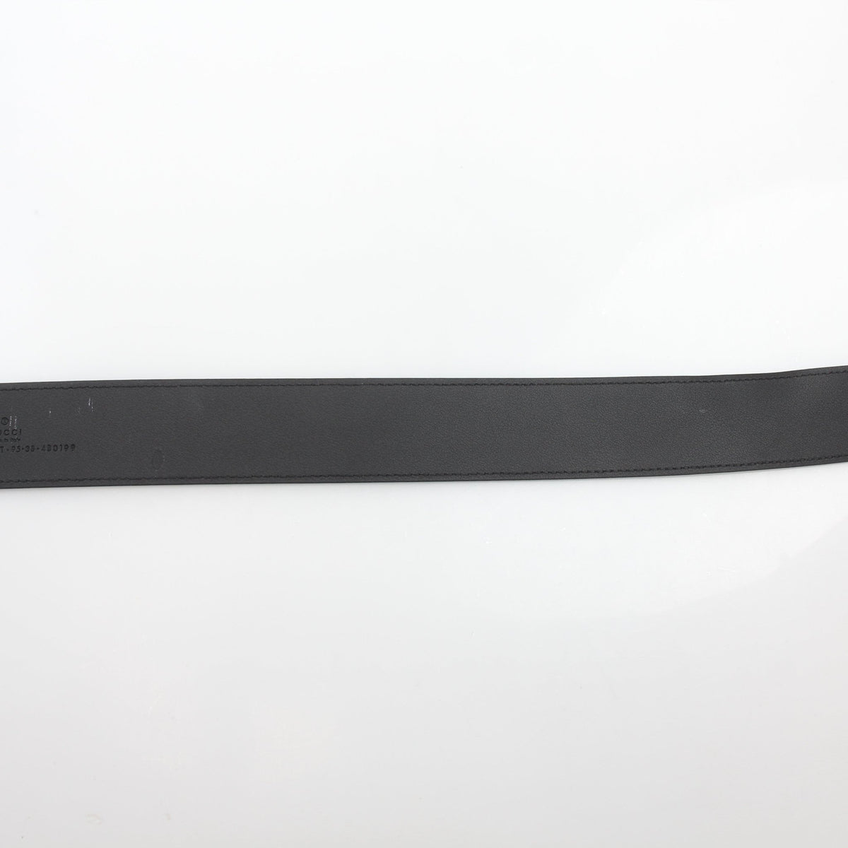 Black leather Gucci GG Marmont wide belt with gold-tone hardware, displayed as an accessory on a neutral background.