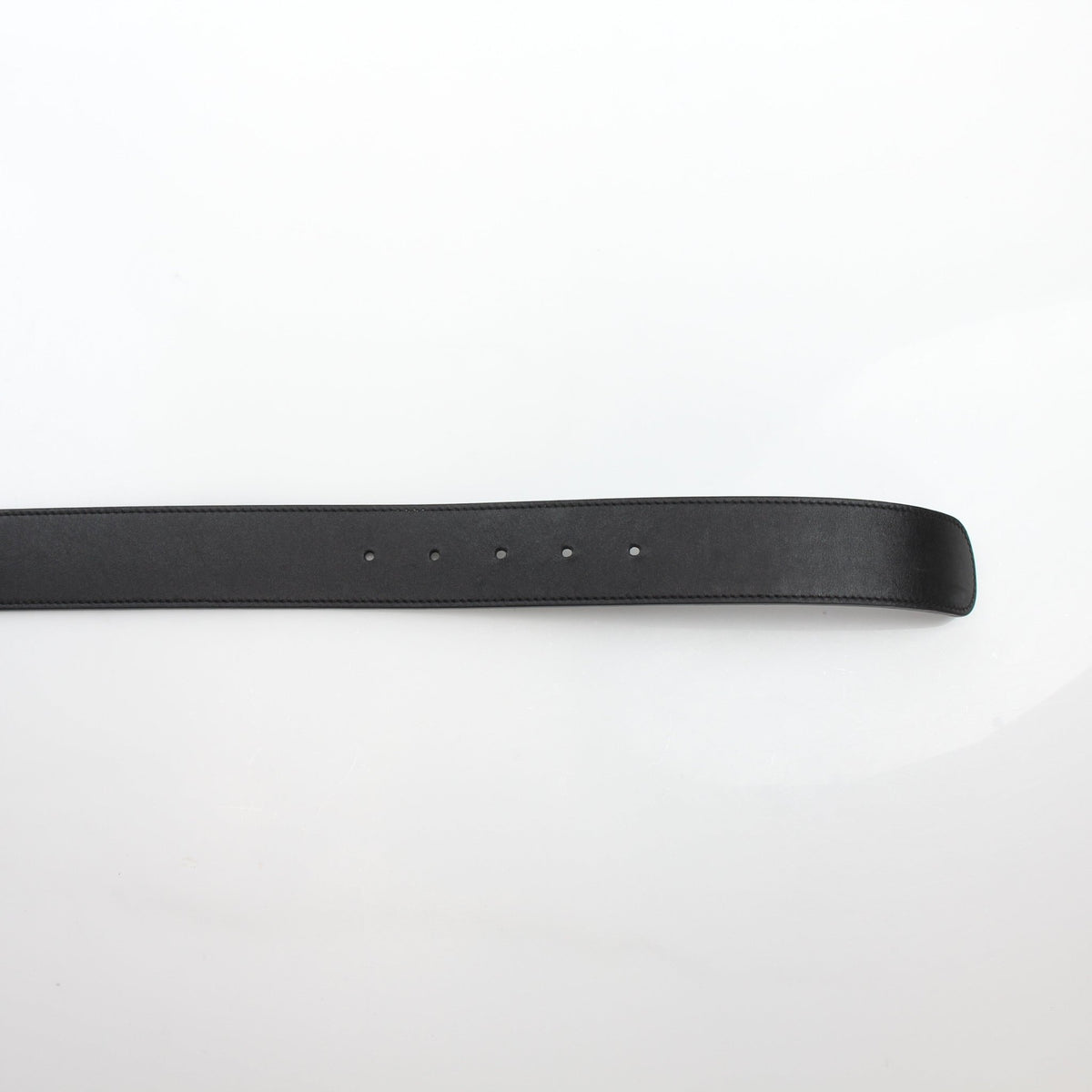Black leather Gucci GG Marmont wide belt with gold hardware, showcasing the signature double G logo and stylish design.