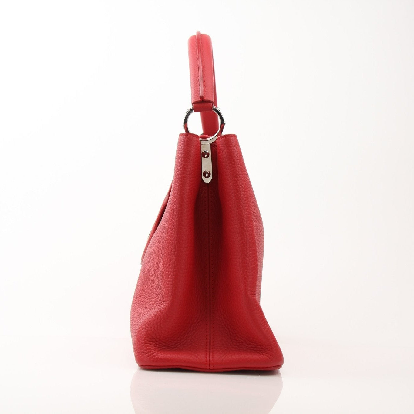 Louis Vuitton Capucines MM handbag with leather handles and gold hardware, displayed on a neutral background.