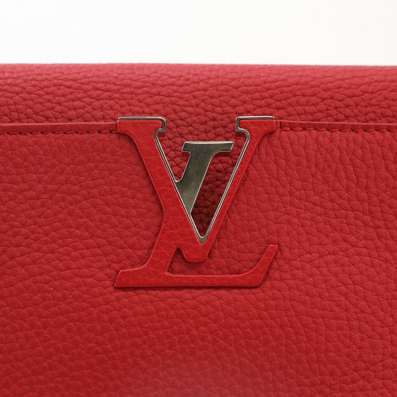 Louis Vuitton Capucines MM handbag with leather handle and gold hardware, showcasing the elegant design and craftsmanship.