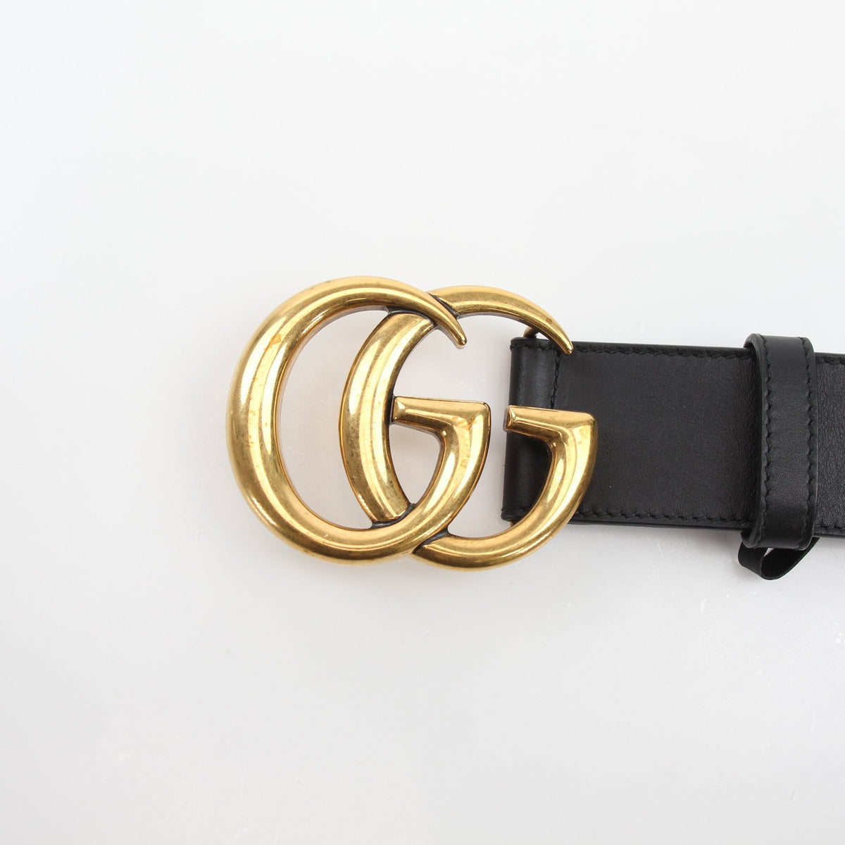 Black Gucci GG Marmont wide leather belt with gold hardware, featuring the signature double G logo and elegant design.