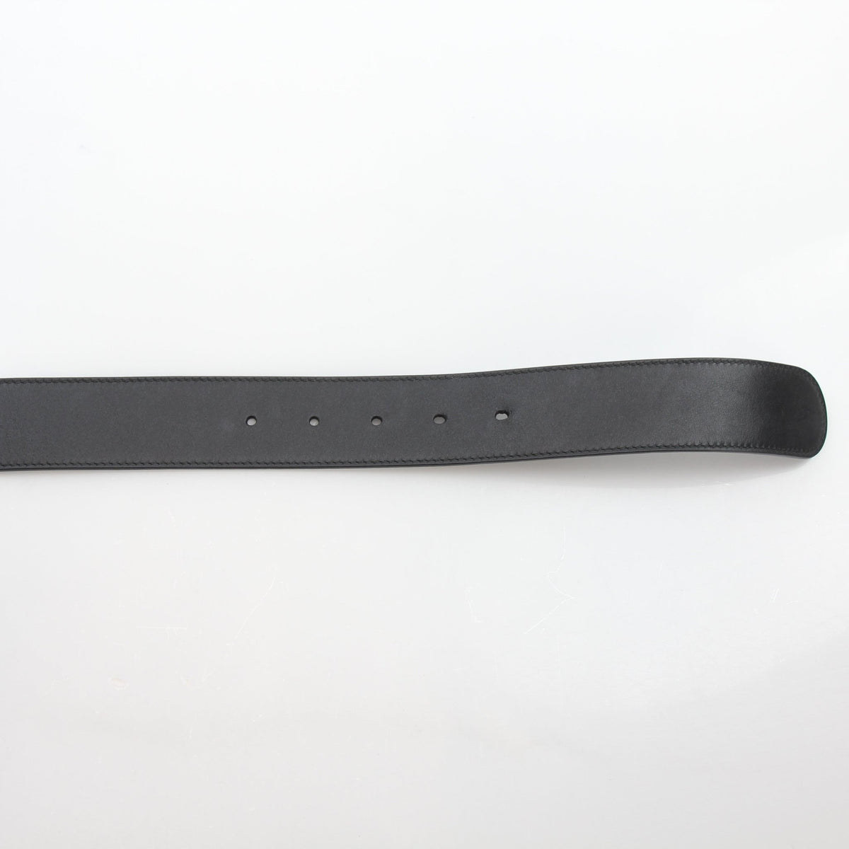 Black leather Gucci GG Marmont wide belt with gold-toned hardware, featuring the signature double G logo buckle.
