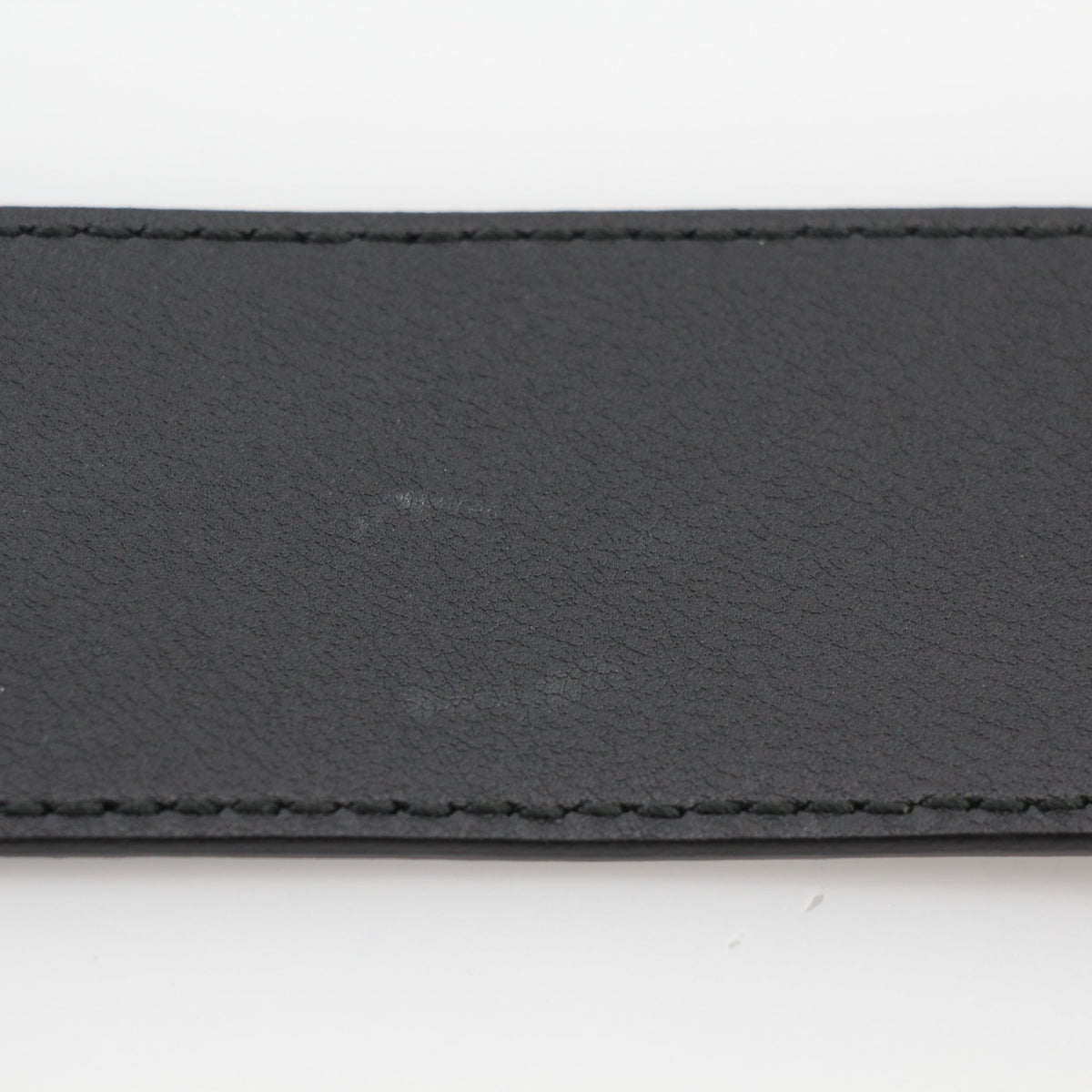 Black leather Gucci GG Marmont wide belt with gold hardware, displayed on a neutral background.
